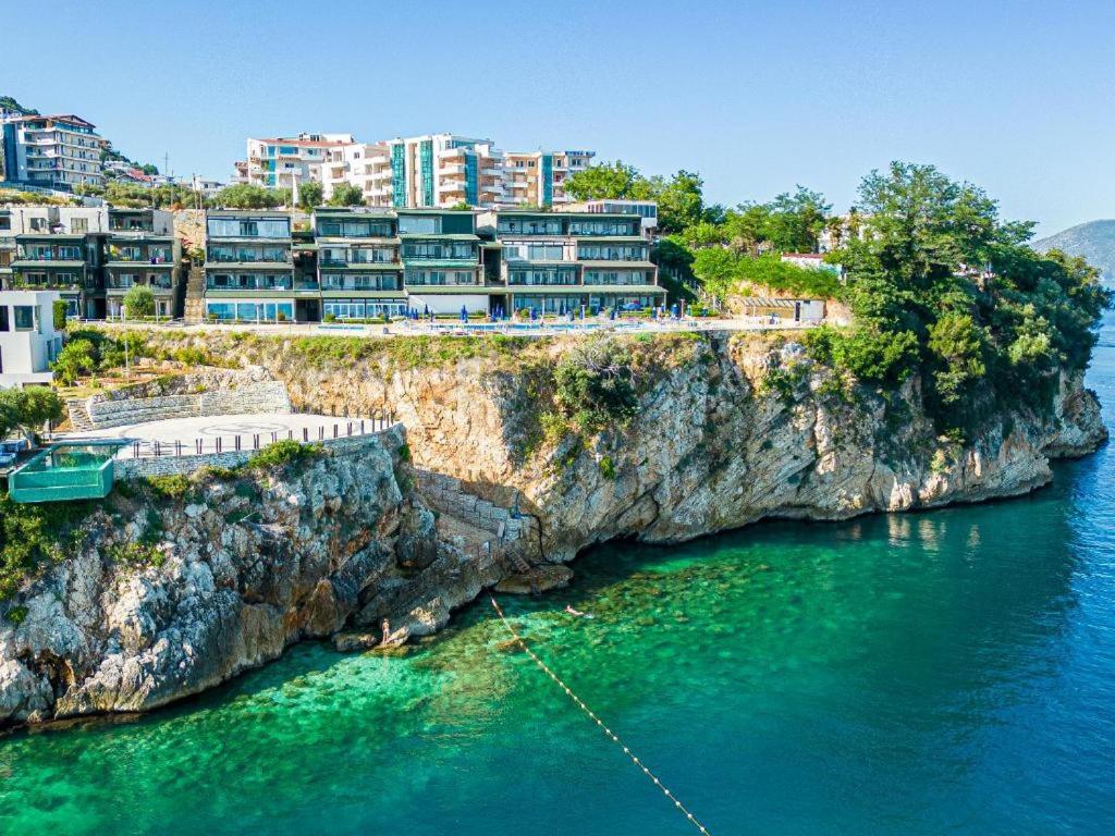 un grupo de edificios en un acantilado junto al agua en Aquamarine Apartments 1, VLORE, en Vlorë