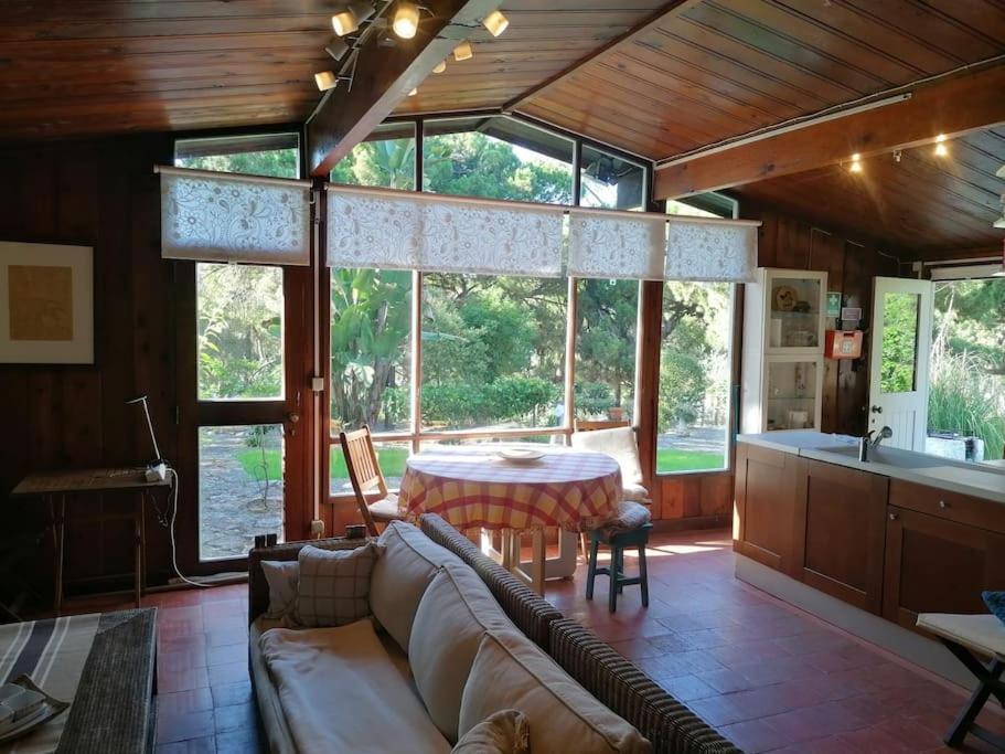 a living room with a couch and a table at Casa da Lagoa in Sesimbra