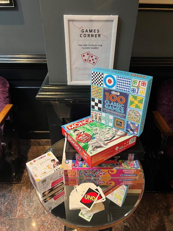 three boxes of games on a glass table at The California - London Kings Cross in London