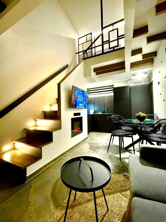 a living room with a staircase and a table and chairs at Modern Home Loft in Alexandroupoli