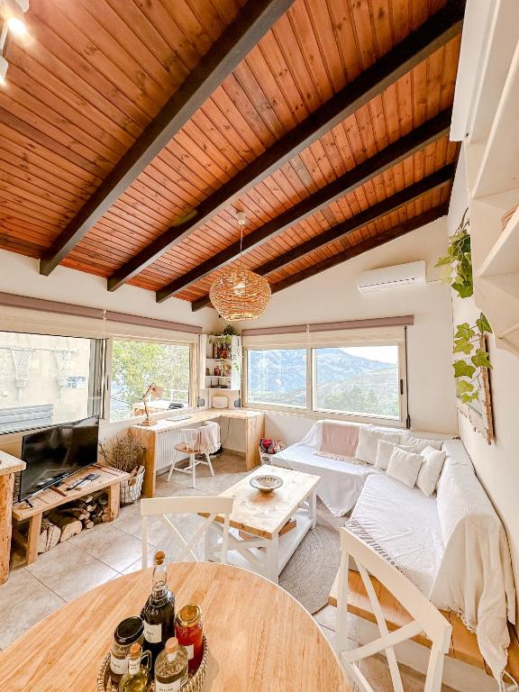 a living room with a couch and a table at Mountain Bliss Guesthouse 1 next to Sougia in Agrilés