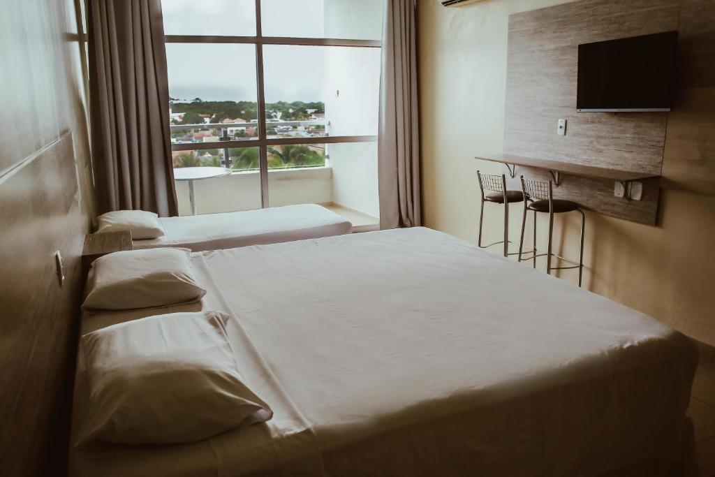 A bed or beds in a room at Barrudada Santarém