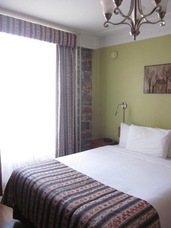 Postel nebo postele na pokoji v ubytování Hôtel Manoir de l'Esplanade