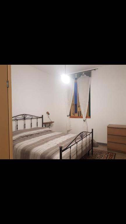 a bedroom with two beds and a window at Da zia Franca in Acate
