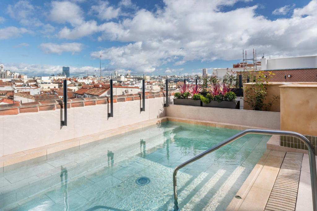 a swimming pool on the roof of a building at Catalonia Atocha in Madrid