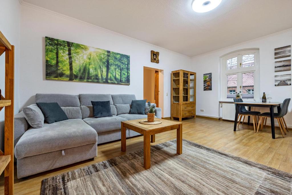 a living room with a couch and a table at Storchenzimmer 2 in Buchholz