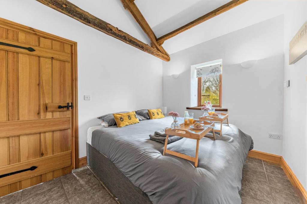 a bedroom with a bed with a table on it at The Byre, Melmerby in Gamblesby