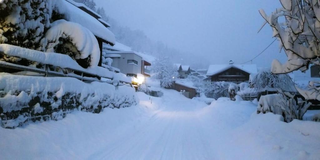 a yard covered in snow with a light on it at groassehof Haus Gstrein in Imsterberg