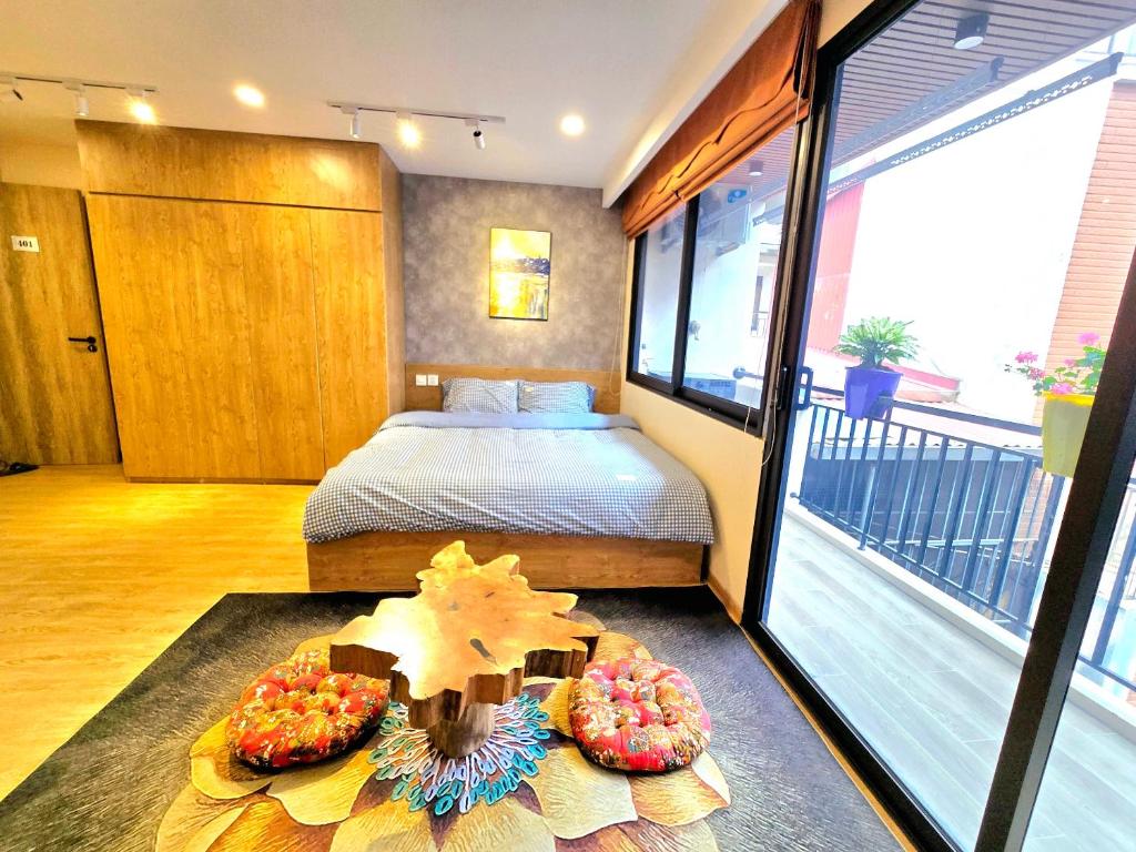 a bedroom with a bed and two donuts on the floor at The Shilla Apartment in Hanoi
