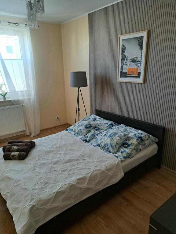 a bedroom with a bed in a room at Słoneczny - Mala Apartamenty in Wejherowo