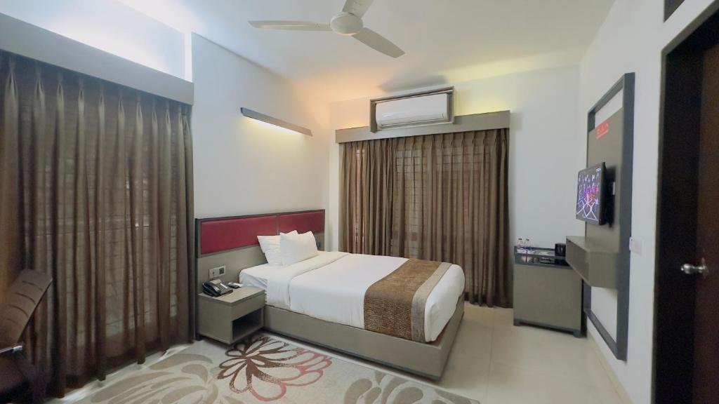 a bedroom with a bed and a large window at Spring Hill Hotel & Apartments in Dhaka