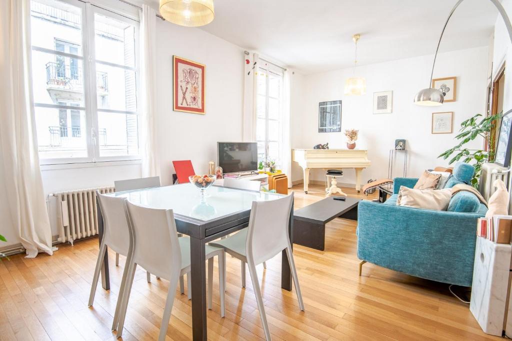 un salon avec une table, des chaises et un canapé dans l'établissement Les Nocturnes de Chopin, à Tours