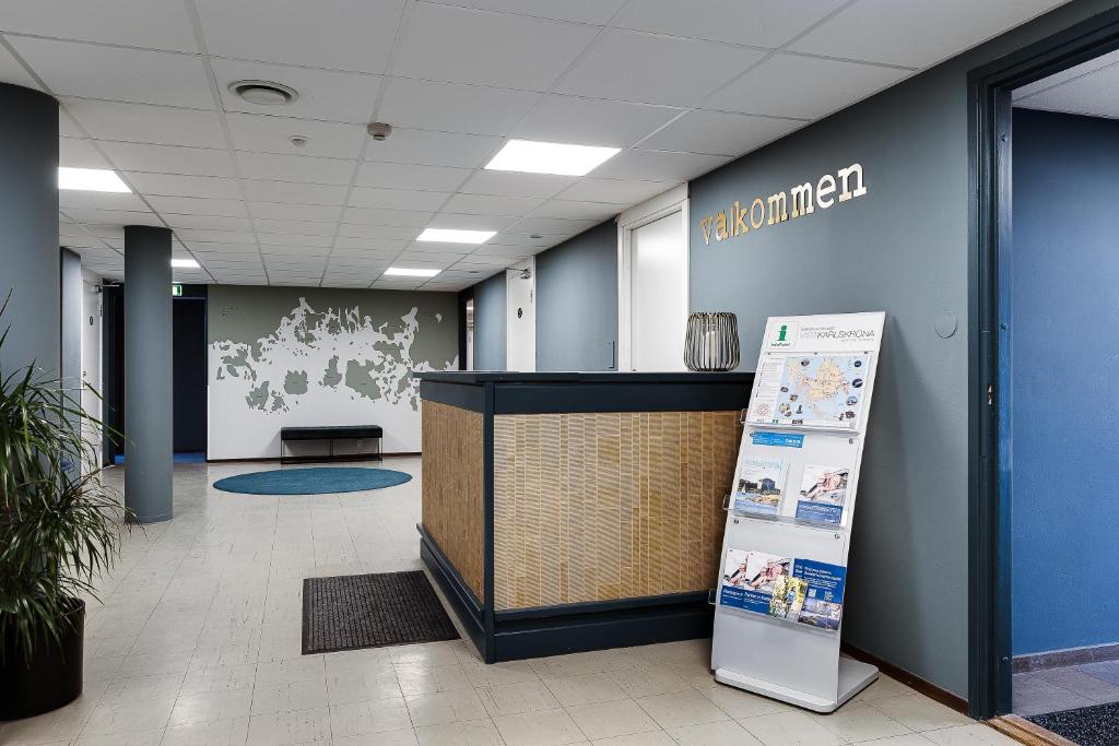 an office lobby with a reception desk and a sign at Drottninggatans Vandrarhem in Karlskrona