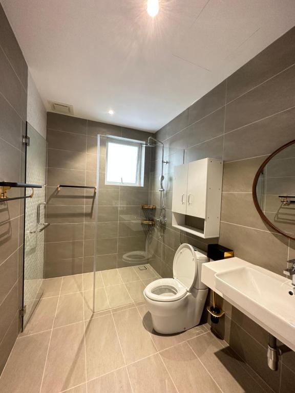 a bathroom with a toilet and a sink at Crystal Suite at Opus Kuala Lumpur in Kuala Lumpur