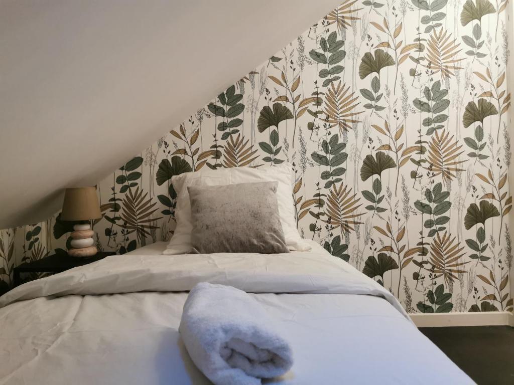 a bed with a stuffed animal on it in a bedroom at La Maison Olivia in La Rivière-Saint-Sauveur