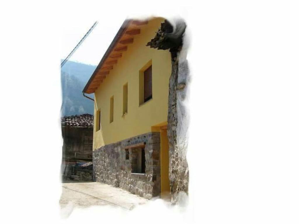 a view of a house through a window at One bedroom house with wifi at Bermiego in Bermiego