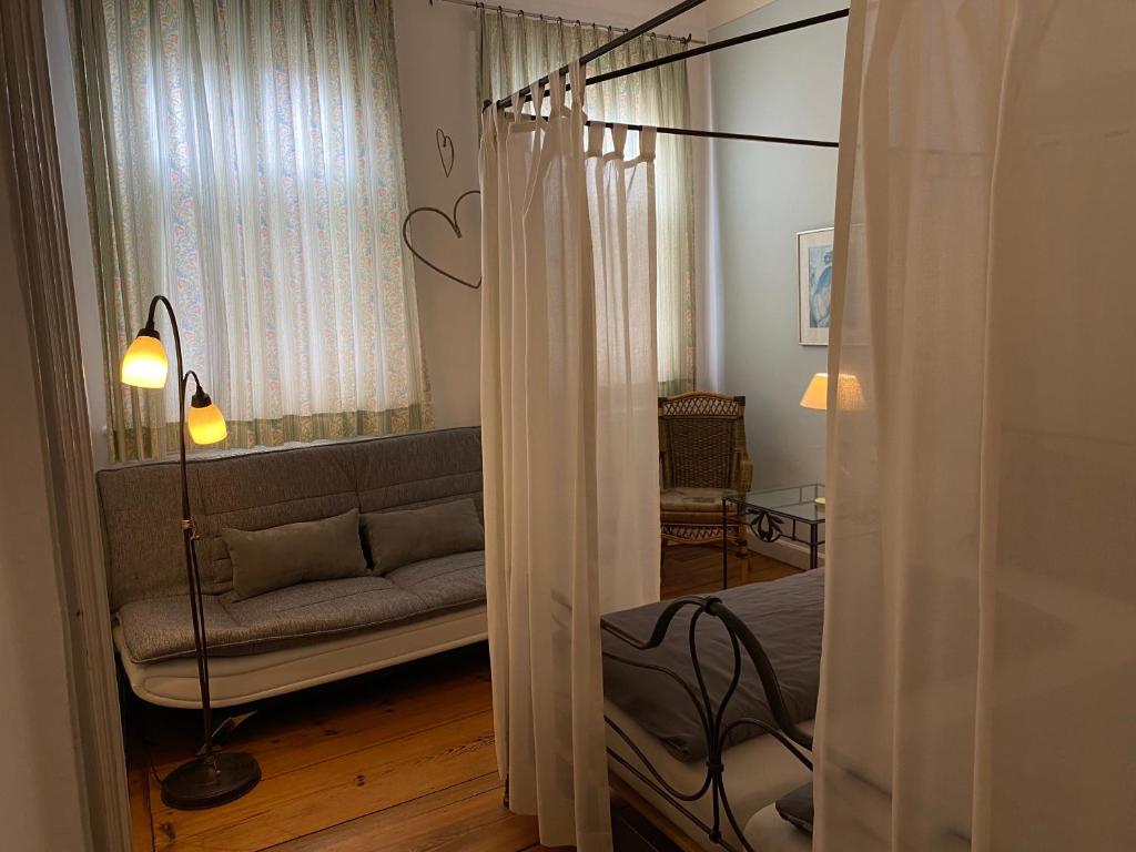 a living room with a couch and a window at Hotel Weinstube am Markt in Gerolzhofen