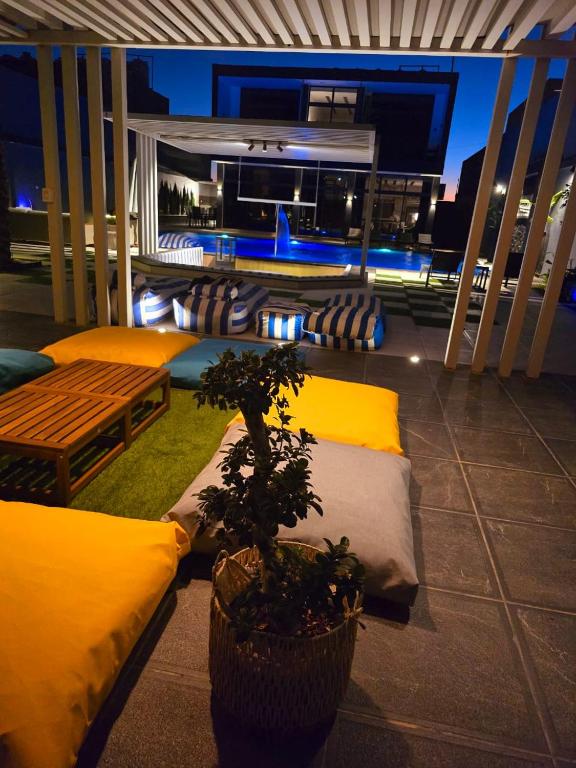 a balcony with two beds and a potted plant at Elysee Villa in Al Rama