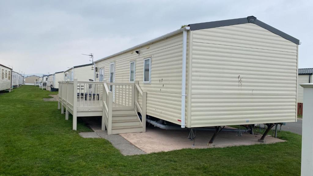 a row of mobile homes parked in a field at 2 Bed Caravan For Hire at Golden Sands in Rhyl in Rhyl