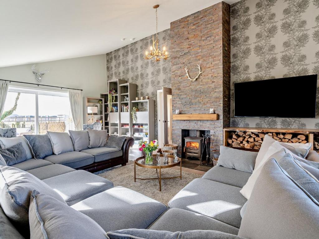 a living room with couches and a fireplace at 6 Bed in South Queensferry 94359 in Broxburn