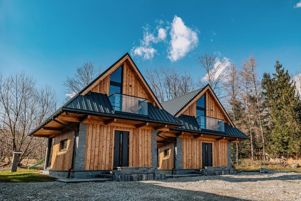 a large wooden house with a gambrel at Domek Siodemka in Zakopane