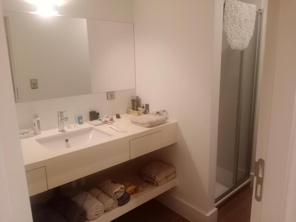 a white bathroom with a sink and a shower at Business accommodation Plus Garden Terrace in Geel