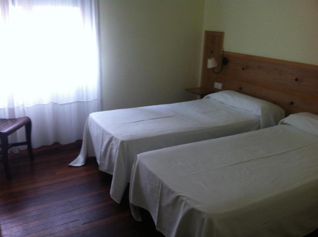 Postel nebo postele na pokoji v ubytování Hotel Boliña