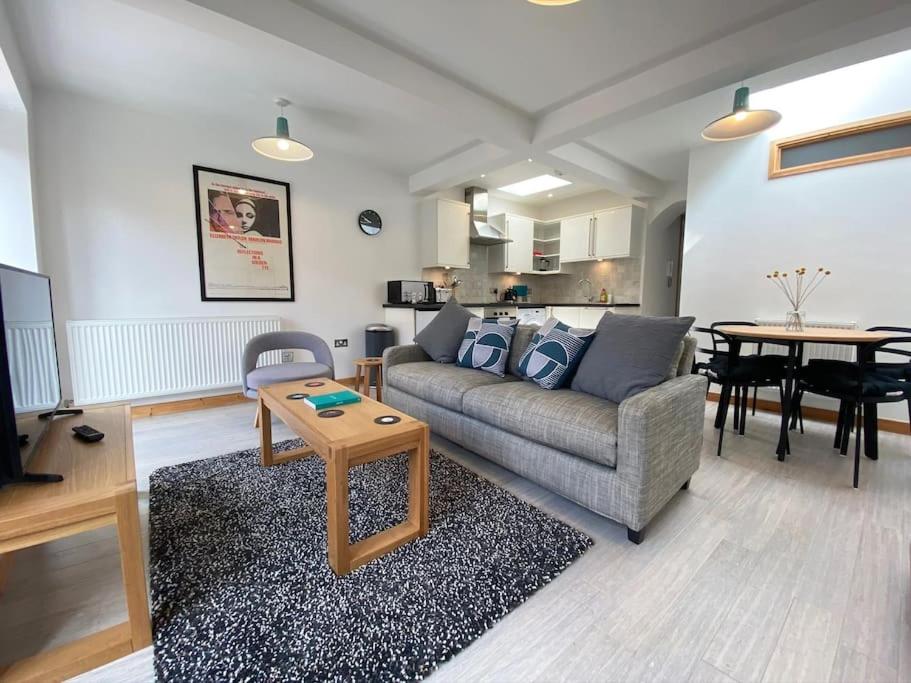 a living room with a couch and a table at St Benedicts Street Flat with Roof Terrace in Norwich