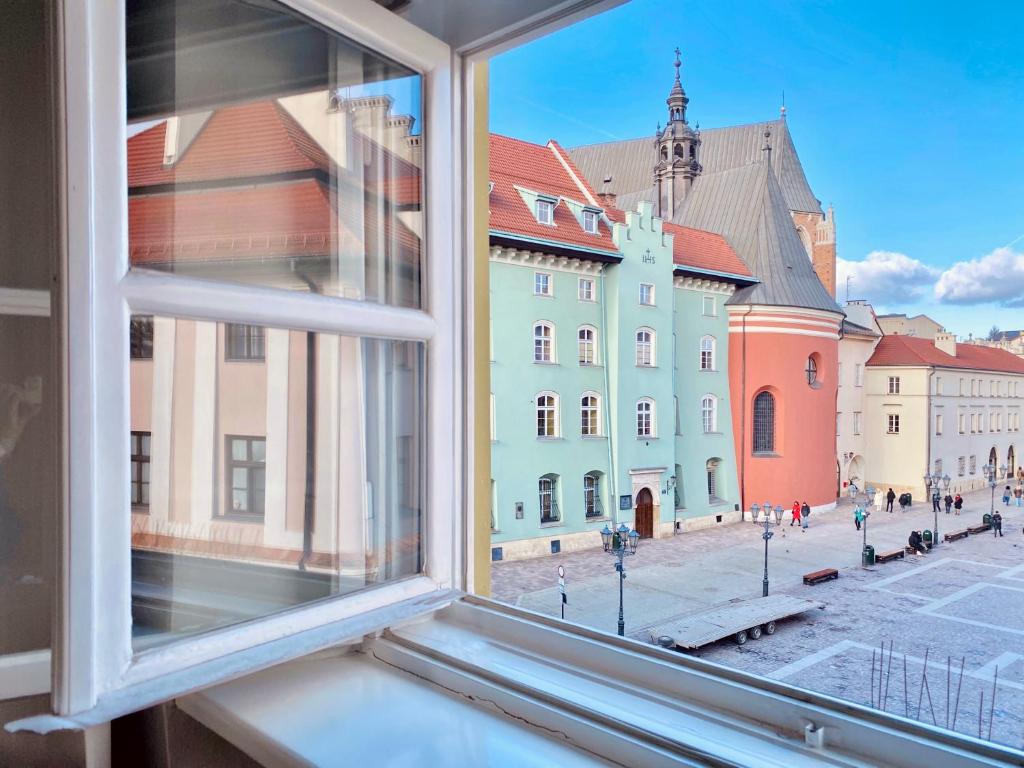 an open window with a view of a city at Mint Luxury Apartments at the Main Square in Krakow