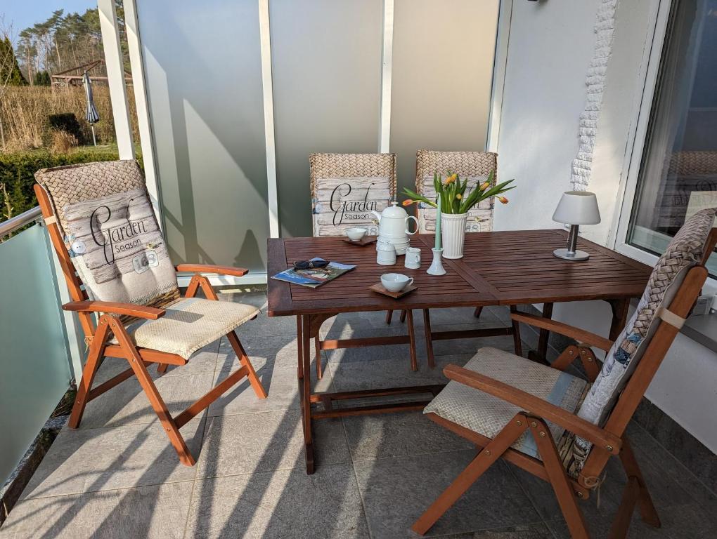 a wooden table and two chairs on a porch at Ferienhaus am See mit Ruderboot in Mustin