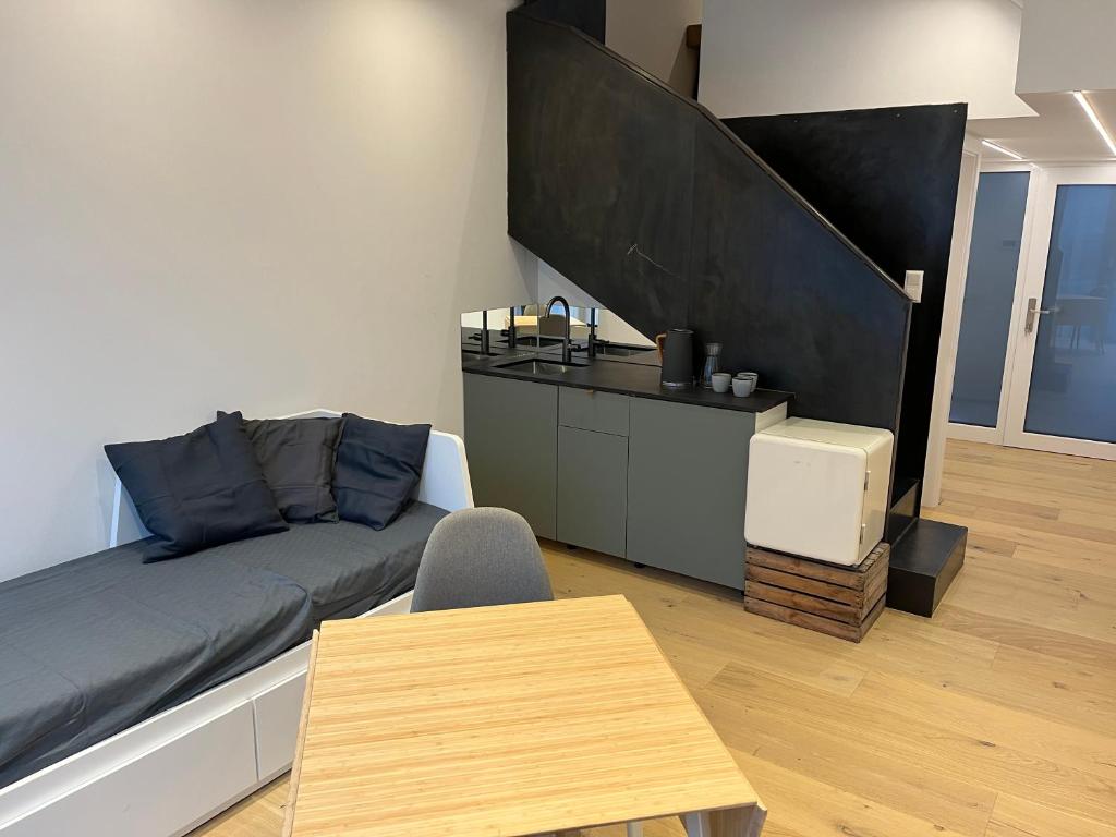 a living room with a couch and a table at Business City Lodge in Sankt Pölten