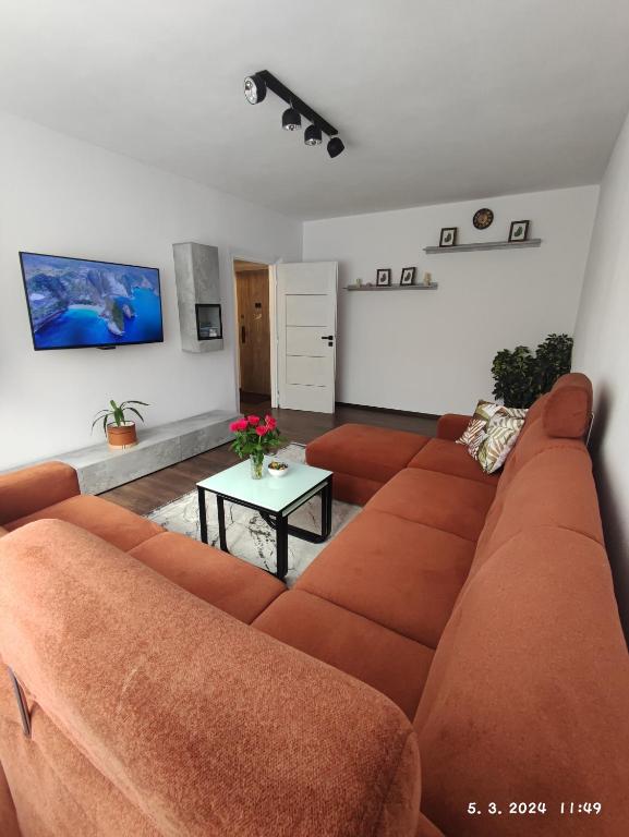 a living room with a couch and a table at Apartmán M&K WEST in Poprad