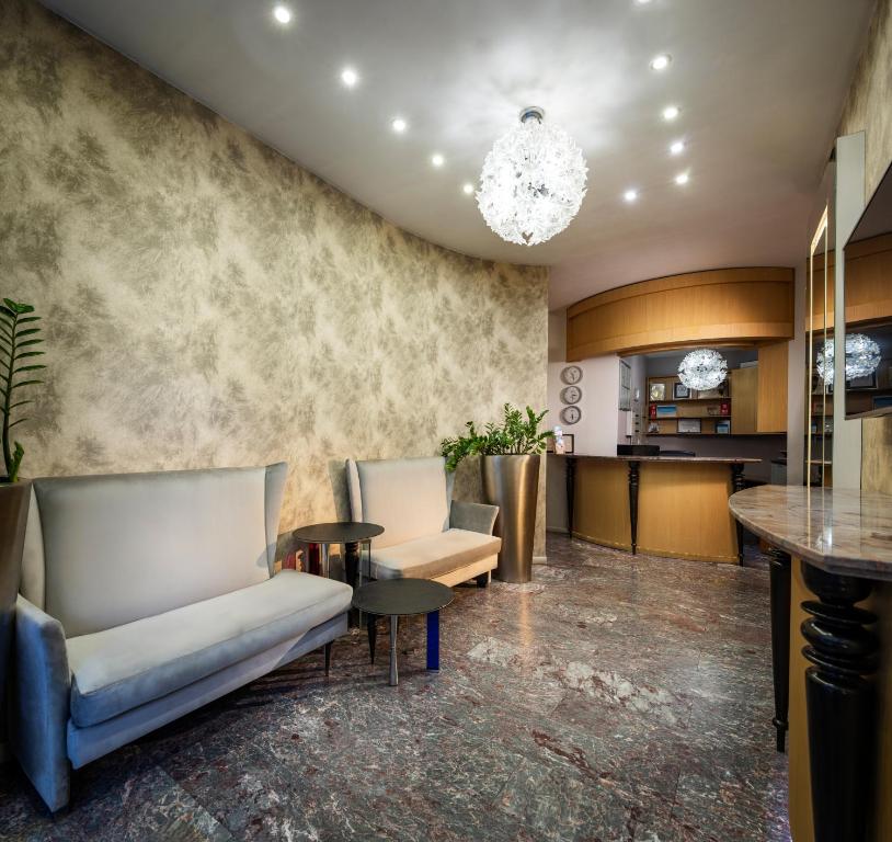 a lobby with a couch and a table at Les Fleurs Boutique Hotel in Sofia
