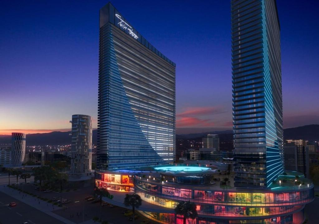 a tall building with a samsung sign on the side of it at Panorama Sea View Orbi City Aparthotel in Batumi