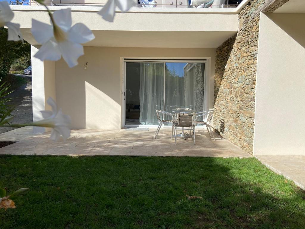 a patio with a table and chairs in a house at Casa Laura in Cervione