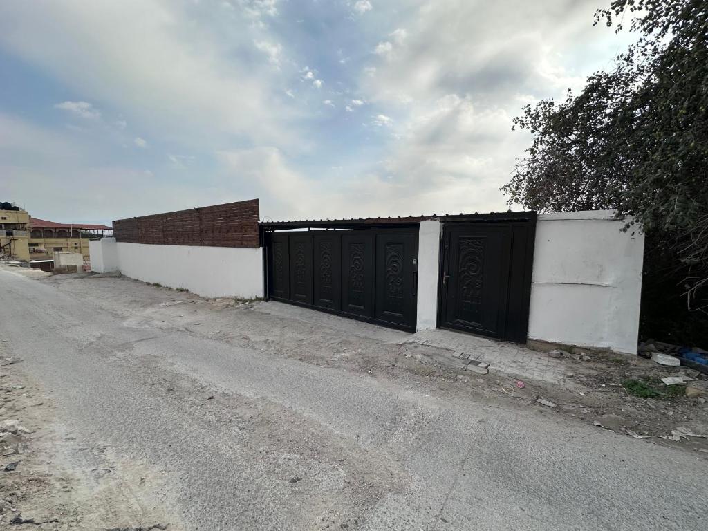 a fence with two gates on the side of a road at Jericho Palestine, Panorama Villa- View, Full Privacy & Pool in Jericho