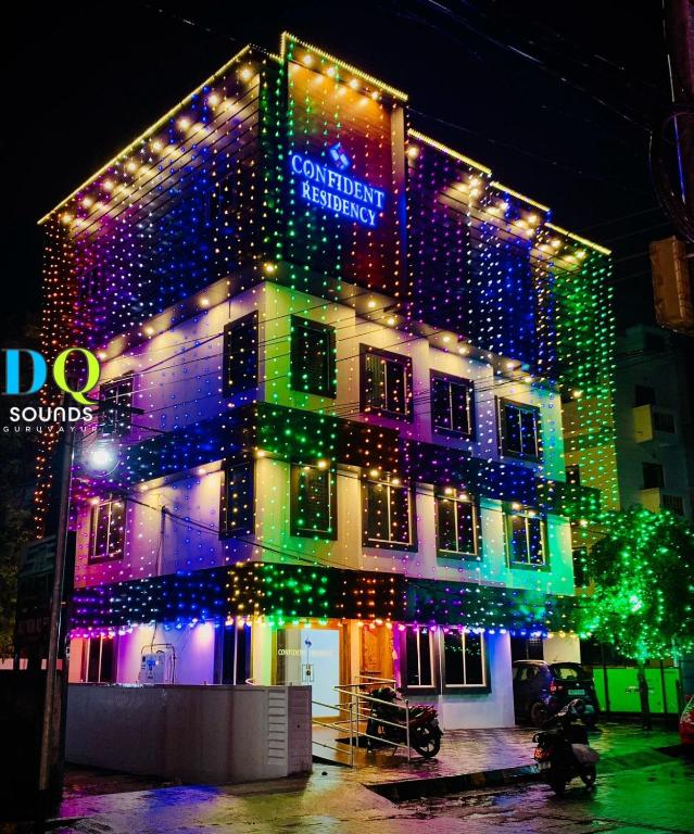 a building with christmas lights on the side of it at Confident Residency in Guruvāyūr