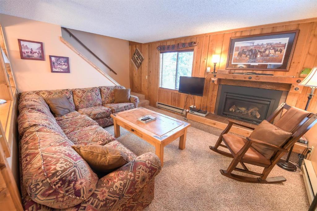 a living room with a couch and a fireplace at Trapper Condo Unit 7 in West Yellowstone