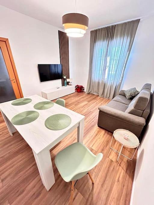 a living room with a white table and a couch at Soleo guesthouse in Monza