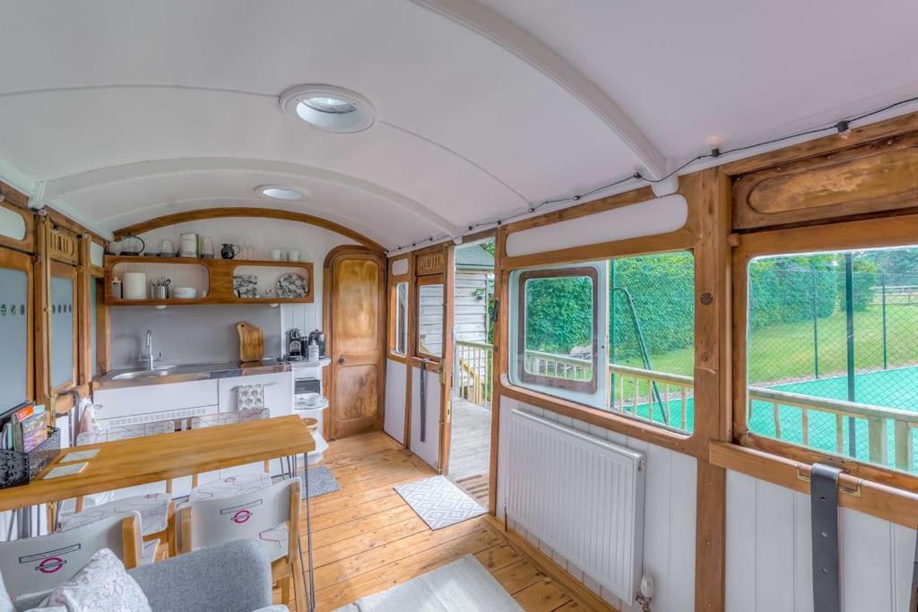 a kitchen and dining room in a train car at Railway Carriage accommodation with tennis court! in Walberton