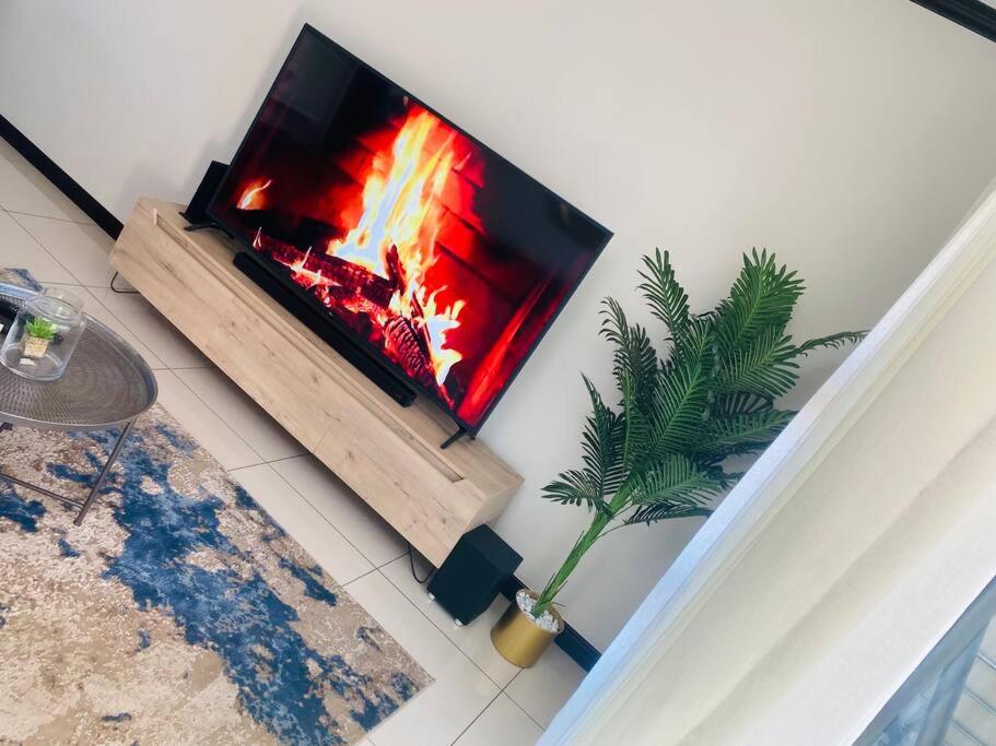 a fire in a fireplace in a living room at LuxuryHome in Midrand