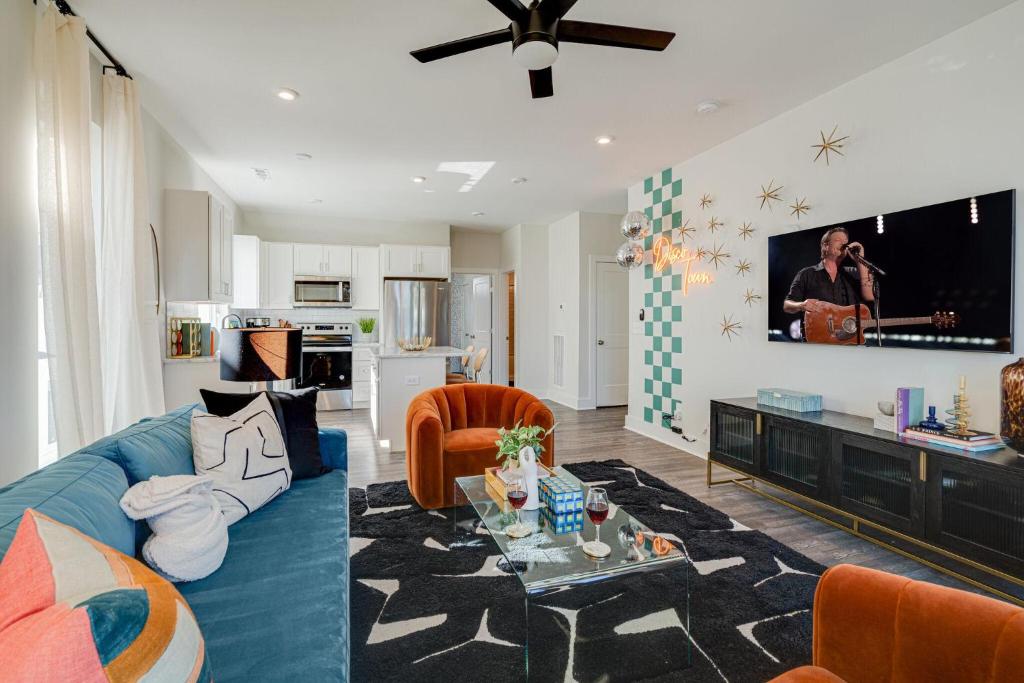 a living room with a blue couch and a tv at Nashville - 5623 Lenox Ave in Nashville