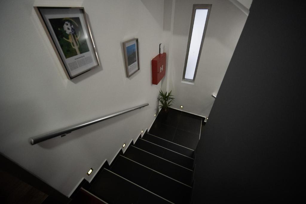 a stairway with a stair railing and a stair case at Sienna Apartments in Skopje