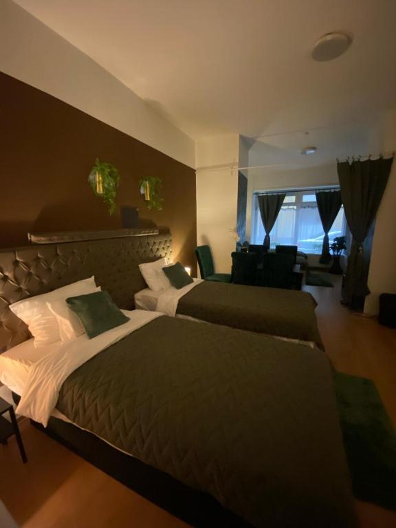 a bedroom with two beds and a living room at Allaga City Center in Budapest
