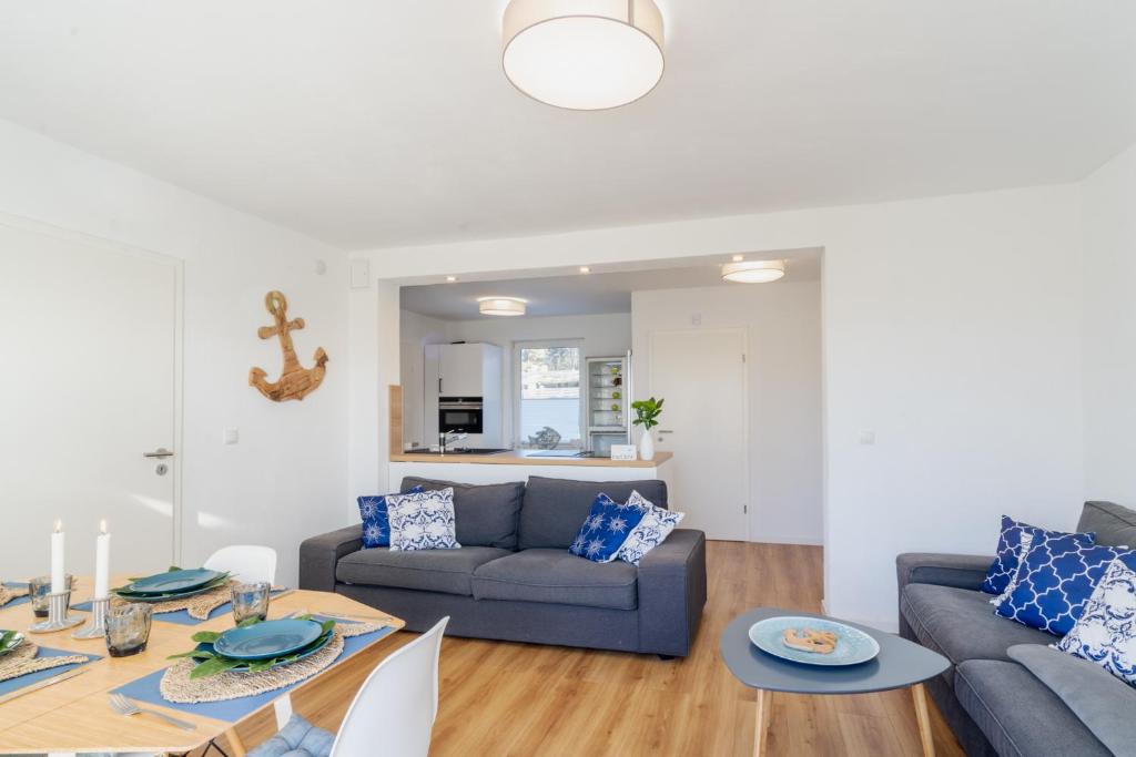 a living room with a couch and a table at ,,Haus MARSI'' idyllische Doppelhaushälfte am Banzelvitzer Strand in Rappin