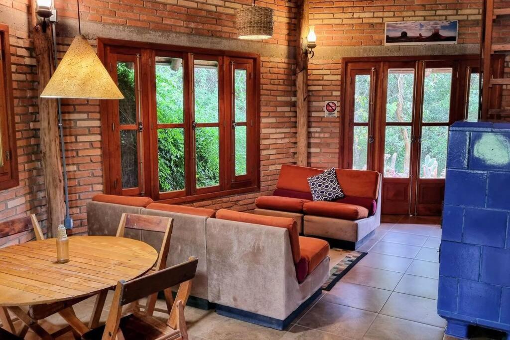 a living room with a couch and a table at Cabana no Rincão Gaia in Pântano Grande