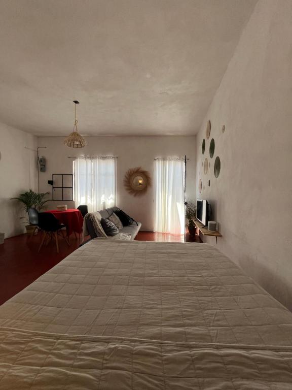 a bedroom with a large bed in a room at Casa Roma in Taxco de Alarcón
