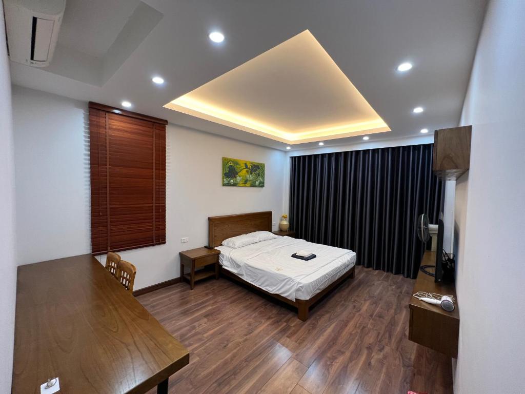 a bedroom with a bed and a table in a room at 54 homestay văn miếu in Hanoi