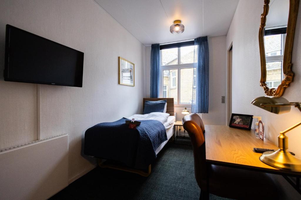 Postel nebo postele na pokoji v ubytování Milling Hotel Windsor