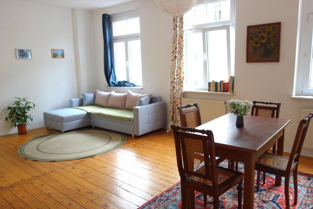 a living room with a couch and a table at 2R-Wohnung am Rande der Neustadt in Dresden